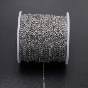 Macro shot of silver plated metal cross chain on a spool for DIY jewelry making