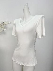 Detail of white V-neck short sleeve T-shirt with padded shoulders on mannequin