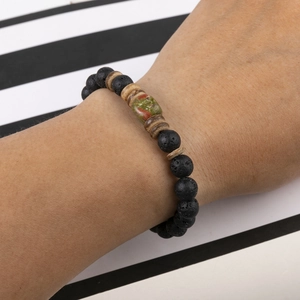 Men's crown beaded bracelet with volcanic stone and wooden beads on model wrist