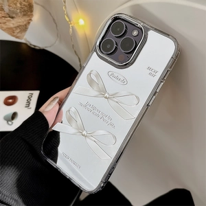 Close-up of silver mirror iPhone case featuring 3D bow decoration and pearl details