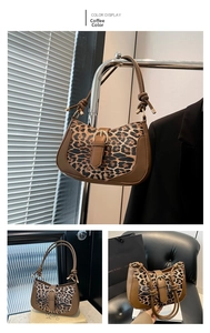Detail of leopard print canvas bag with brown leather trim and knotted shoulder strap