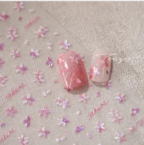 Macro shot of 3D embossed Sakura nail stickers with pink tulip designs and floral textures
