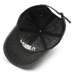 Inside view of a vintage washed black baseball cap with 6-panel structure and metal buckle