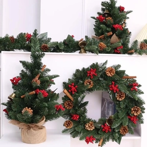 Christmas decoration set with pine tree, red berries, cones, and golden bells on white