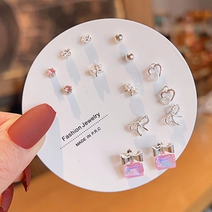 Detailed set of twelve unique titanium steel earrings including bows and crystals