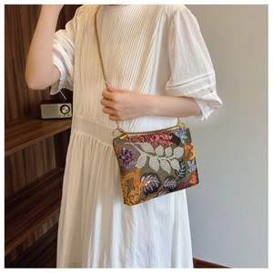 Detailed embroidery and sequins with golden chain strap on a vintage evening clutch bag