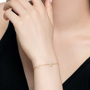 Detailed view of gold butterfly bracelet with pavé cubic zirconia on delicate chain