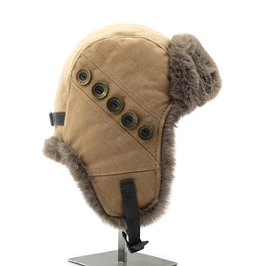 Detail of winter trapper hat showing khaki canvas and metal buttons with city names