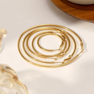 Set of four polished 18K gold plated stainless steel hoop earrings in various sizes