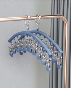 Detail of multi-clip windproof drying rack with non-slip clips in a modern indoor setting
