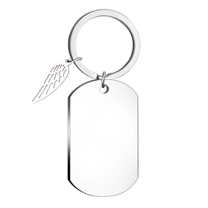 Detailed close-up of polished silver metal keychain with feather wing and rectangular dog tag