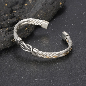 Detail of twisted cable texture and central knot on silver titanium steel bracelet