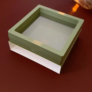 Detail of green square suspension jewelry box with transparent film and push button opener