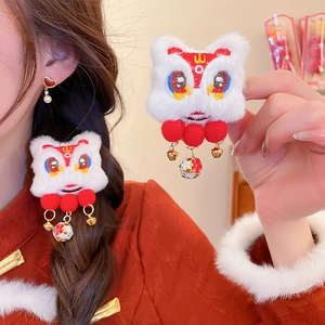 Detail of red lion dance hair clip with white plush, golden bells and tassels