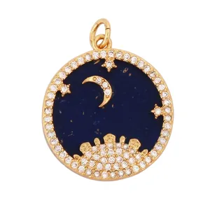 Macro shot of gold micro-pave moon and star coin pendant with blue enamel and cubic zirconia