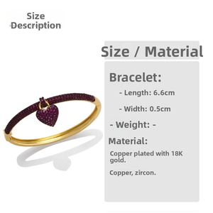Detail of 18K gold-plated copper bangle with heart pendant and purple zircon stones