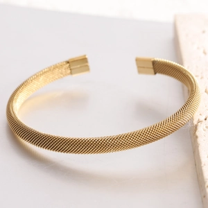 Golden 7mm mesh C-shaped stainless steel bracelet with textured weave and open design