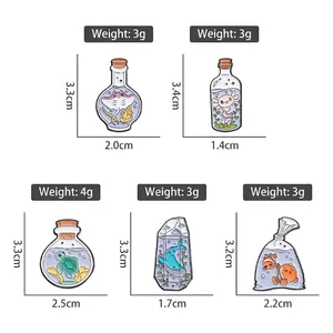Set of ocean life enamel pins featuring sea turtles and whale in glass bottles