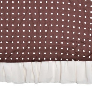 Detail of French polka dot satin dress with ruffle hem and premium flowing fabric texture