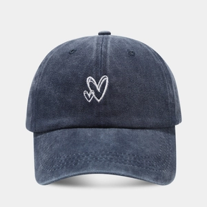 Washed navy blue baseball cap with white double heart embroidery and adjustable strap