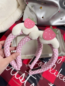 Detail of pink plaid headbands featuring white cloud plush and strawberry felt decoration