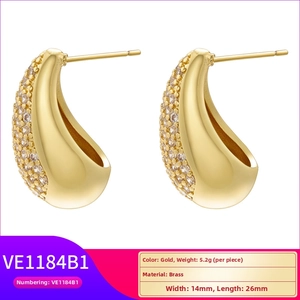 Detail view of gold-plated twisted U-shape earrings with micro-pave cubic zirconia