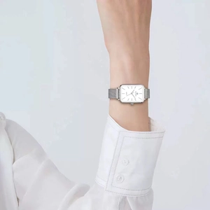Women's vintage square quartz watch with silver mesh strap on model wrist