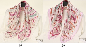 Close-up of two satin silk scarves with colorful paisley patterns and artistic oil painting prints