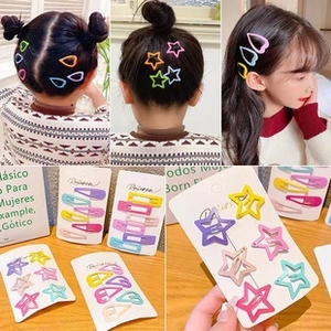 Macro view of colorful candy-colored matte hair clips in various geometric shapes