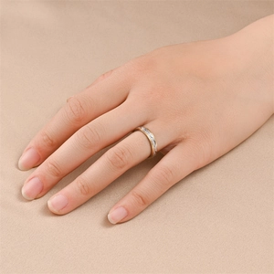 Detail view of a titanium steel two-tone minimalist ring worn on a hand