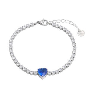 Macro shot of silver tennis chain bracelet with a large blue heart zircon and S.steel tag