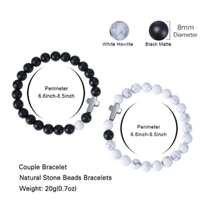 White howlite and black matte stone couple beaded bracelet with cross charm on white background