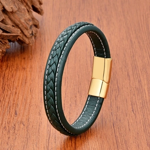 Detail of green woven leather bracelet with white stitching and gold magnetic clasp
