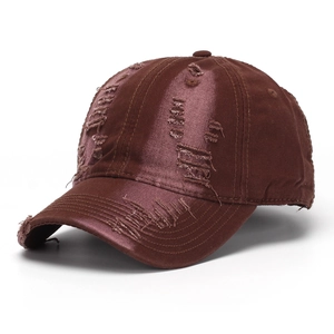 Close-up of distressed details and satin finish on a vintage red-brown denim baseball cap