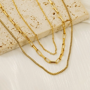 Three-layer gold stainless steel necklace featuring box, paperclip, and cable chains