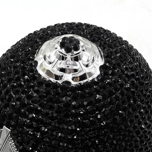 Macro detail of black rhinestones and silver floral metal ornament on fancy evening bag