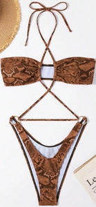 Detail of snake skin pattern bikini with gold metal ring accents and crossover halter straps
