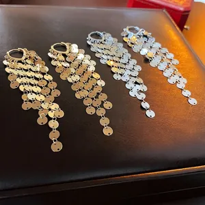 Metallic sequin tassel hoop earrings in polished gold and silver finishes