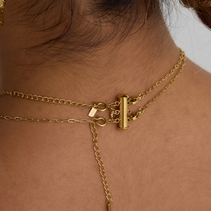 Detail of 18k gold plated stainless steel layered necklace clasp and S.STEEL tag