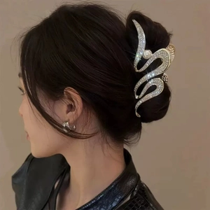 Elegant wavy silver shark clip with rhinestones and pearls worn on hair side profile