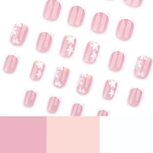 Short square press-on nails with white French tips and delicate spring flower patterns