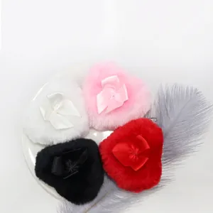 Set of 4 heart-shaped plush powder puffs with satin bows in pink, red, black, and white