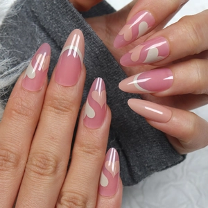 Pink almond press-on nails with heart patterns and French white tips for Valentine