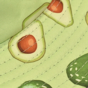 Close-up of avocado print bucket hat fabric with professional parallel stitching detail