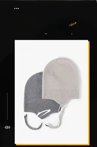 Close-up of fine knit ear-protection beanies in light and dark gray with rope details
