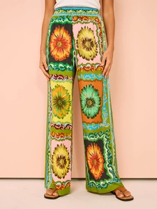Detail showing elastic high waist and colorful floral print on breezy wide-leg trousers