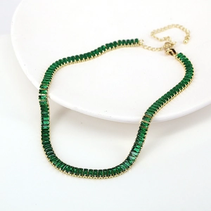 Detail of adjustable tennis necklace with green rectangular zircon in gold finish