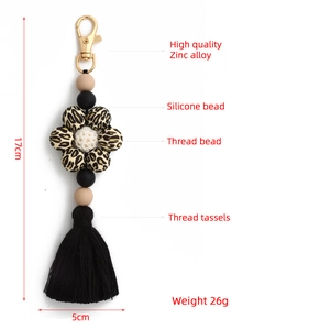 Detailed view of silicone beaded keychain with leopard print, tassel and gold-tone clasp