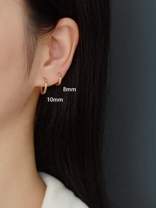 Close-up of 8mm and 10mm gold S925 silver hoop earrings with colored zircons on model