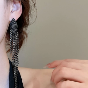 Detailed close-up of long black jellyfish tassel earrings with sparkling rhinestones